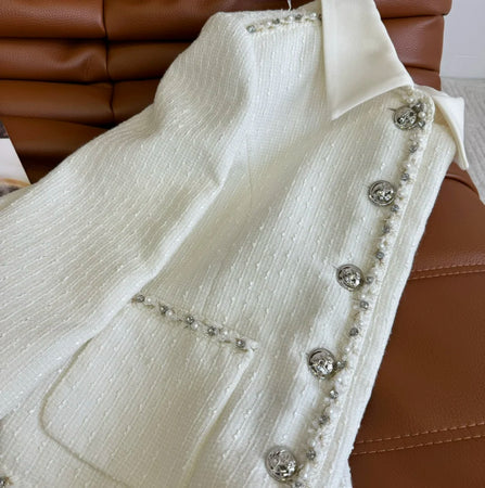 High end pearl trimmed short skirt set, featuring a short jacket paired with a high waisted skirt, exuding a luxurious  vibe